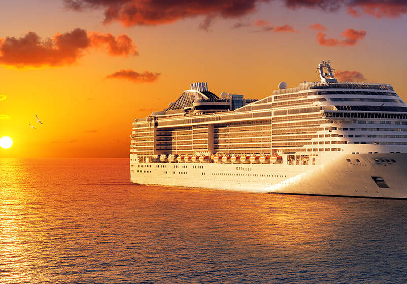 lone cruise ship on the ocean at sunset